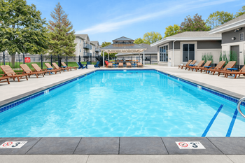 Swimming pool with lounge chairs and covered seating